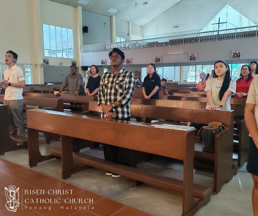 Inside the church: pews, clear windows, and the peaked white roof above